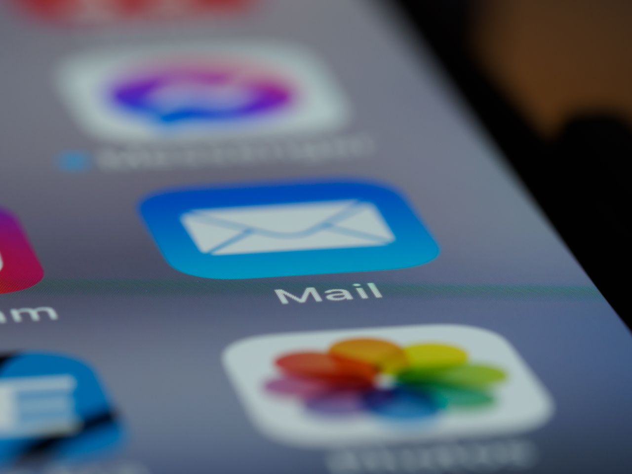 services-01 Detailed close-up of an email app icon on a smartphone screen, showcasing modern technology.